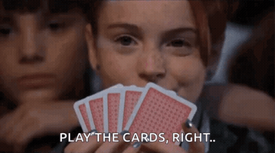 Woman Holding Playing Cards In Front Of Face GIF