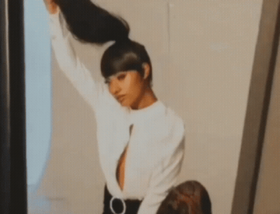 Woman Holding Ponytail In Mirror GIF
