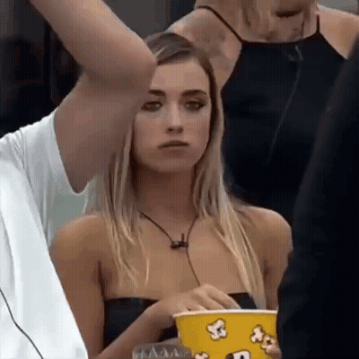 Woman Holding Popcorn Bucket Man Holds Her Arm GIF