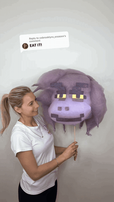 Woman Holding Purple Hippo Cotton Candy Saying Eat It GIF