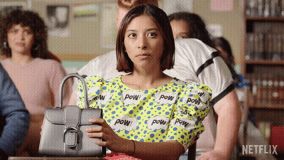 Woman Holding Purse In Front Of Netflix Logo GIF