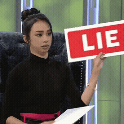 Woman Holding Red Lie Sign GIF