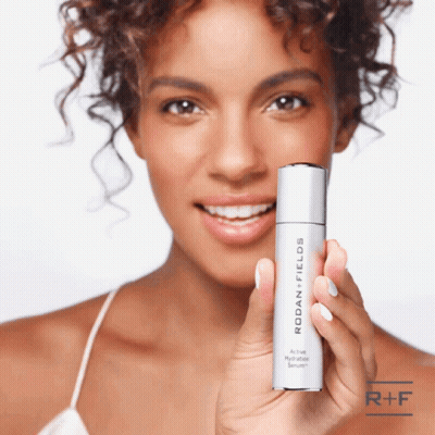 Woman Holding Rodan Fields Hydration Serum GIF