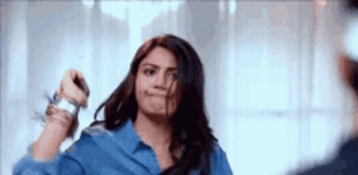 Woman Holding Scissors In Front Of Mirror GIF