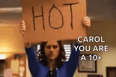 Woman Holding Sign Hot Carol You Are A 10+ GIF