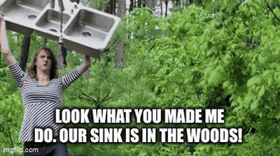 Woman Holding Sink Over Head In Forest GIF