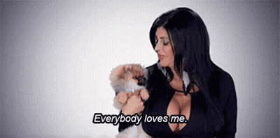 Woman Holding Small Dog Says Everybody Loves Me GIF