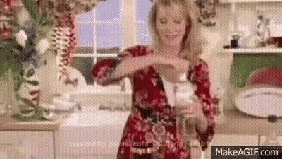 Woman Holding Soap Bottle In Kitchen GIF