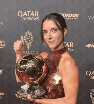 Woman Holding Soccer Ball In Front Of Qatar Airways Sign GIF