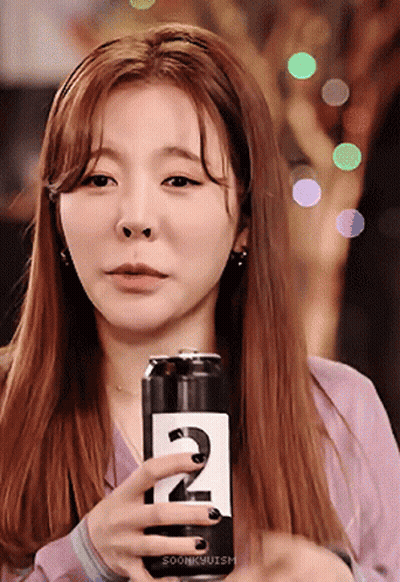Woman Holding Soda Can With Number 2 GIF