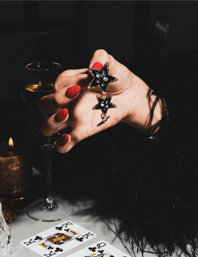 Woman Holding Star Earrings And Wine Get Our Black Friday Deal GIF