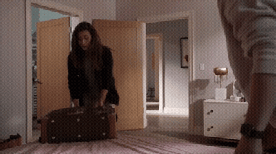 Woman Holding Suitcase In Bedroom GIF
