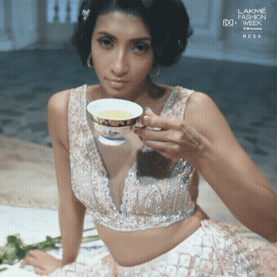 Woman Holding Tea At Lakme Fashion Week Nexa GIF