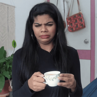 Woman Holding Tea Cup Making Funny Face GIF