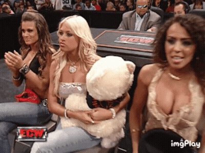 Woman Holding Teddy Bear In Front Of Ew Sign GIF