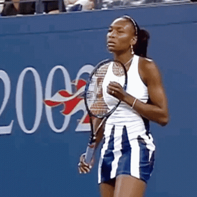 Woman Holding Tennis Racquet In Front Of Wall Number 2 GIF