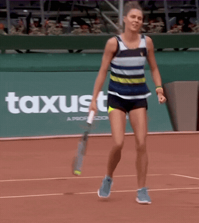 Woman Holding Tennis Racquet On Court With Axusto Sign GIF