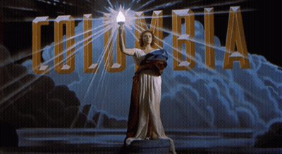 Woman Holding Torch In Front Of Columbia Logo GIF