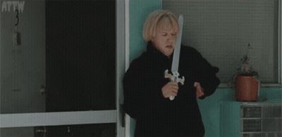 Woman Holding Toy Sword in Front of Door Number 3