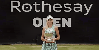 Woman Holding Trophy In Front Of Rothesay Open Banner GIF