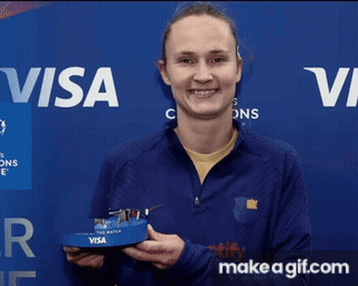 Woman Holding Trophy In Front Of Visa Banner GIF