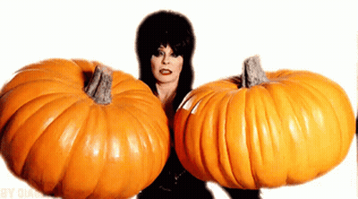Woman Holding Two Large Pumpkins In Front Of Face GIF