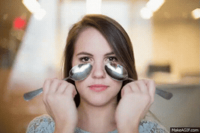 Woman Holding Two Spoons To Eyes GIF