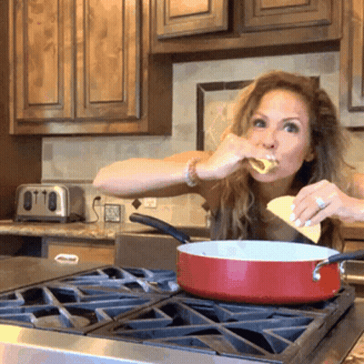 Woman Holding Two Tacos In Front Of Group GIF