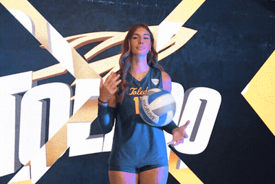Woman Holding Volleyball In Front Of Toledo Wall GIF