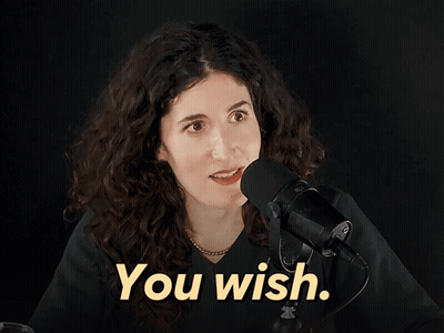 Woman Holding Voodoo Doll Talking On Phone GIF