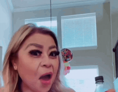 Woman Holding Water Bottle By Window GIF