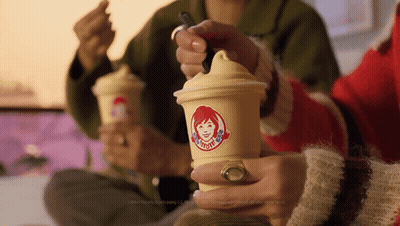 Woman Holding Wendy's Cup With Spoon GIF
