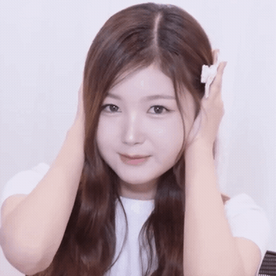 Woman Holding White Object GIF