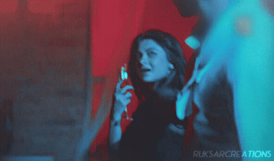 Woman Holding Wine In Front Of Ruksarcreations Sign GIF