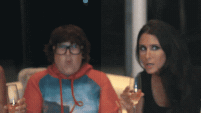 Woman Holding Wine Next To Boy With Glasses GIF