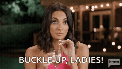 Woman Holding Wine Saying Buckle Up Ladies GIF