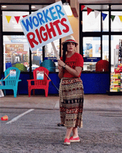 Woman Holding Worker Rights Sign GIF
