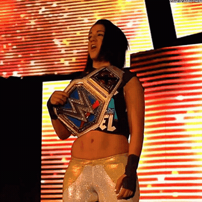 Woman Holding Wrestling Championship Belt On Stage GIF