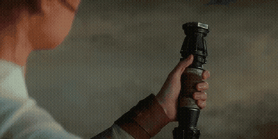 Woman Holding Yellow Lightsaber GIF