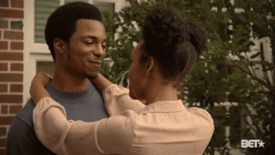 Woman Hugging Man At Brick Building With BET Logo GIF