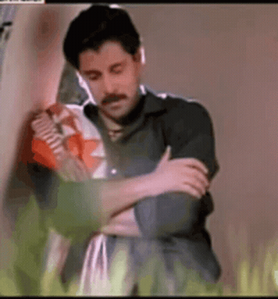 Woman Hugging Man With Arms Crossed GIF