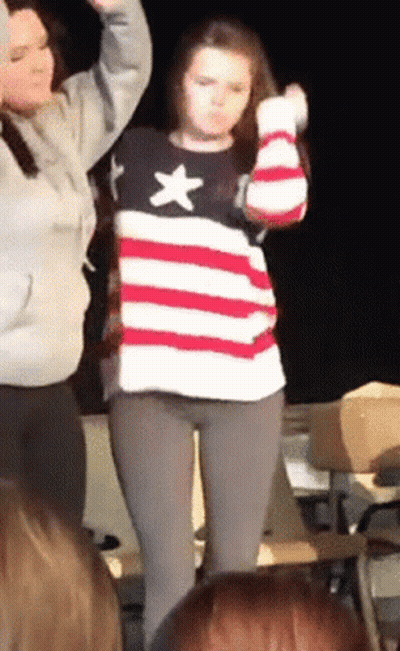 Woman In American Flag Sweater Dancing In Front Of Crowd GIF