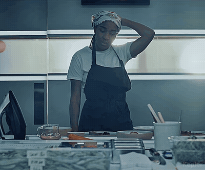 Woman In Apron At Counter With Kepler Sign GIF