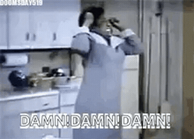 Woman In Apron Drinking Water In Kitchen GIF
