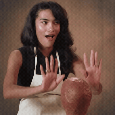 Woman In Apron Holding Head Statue GIF
