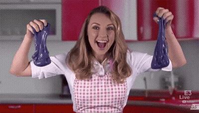 Woman In Apron Holding Purple Slime GIF