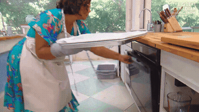 Woman In Apron Pulling Tray From Oven Great Canadian Baking Show GIF