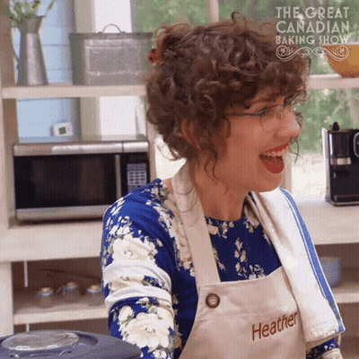 Woman in Apron Saying Heather Smiling