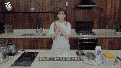 Woman In Apron Standing In Kitchen GIF