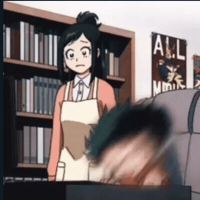 Woman In Apron Standing Next To Man In Library GIF